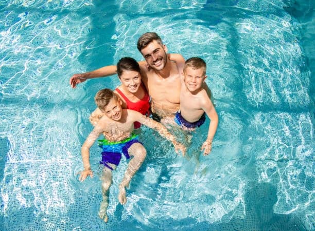 Family enjoying a swimming pool